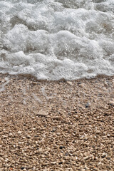 Pebble Shoreline with Crashing Waves and Clear Water