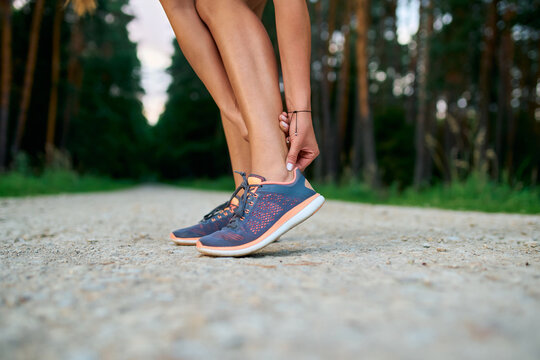 Close-up of female runner touching achilles tendon. Achilles tendonitis injury
