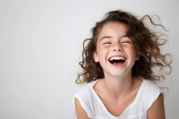 Foto op Plexiglas Portrait of a happy laughing child girl isolated over white background © Danko