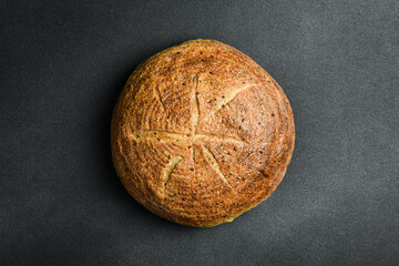Homemade round rye bread. Fresh bread on a black background. Top view.