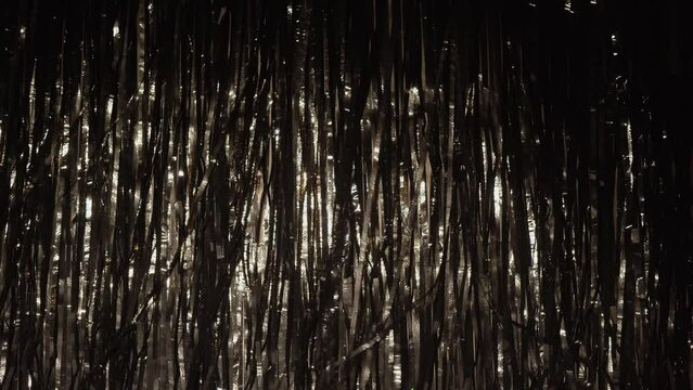Festive black tinsel as background and texture. Party Background
