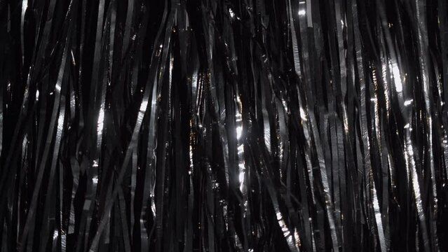 Black foil tinsel fringe background for stage, New Years, birthday. Celebration, pary or event