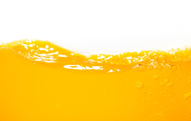Close up bright orange juice splash texture for health and nature waves, Beautiful waves curve and little bubbles smooth for garphic design and background - obrazy, fototapety, plakaty