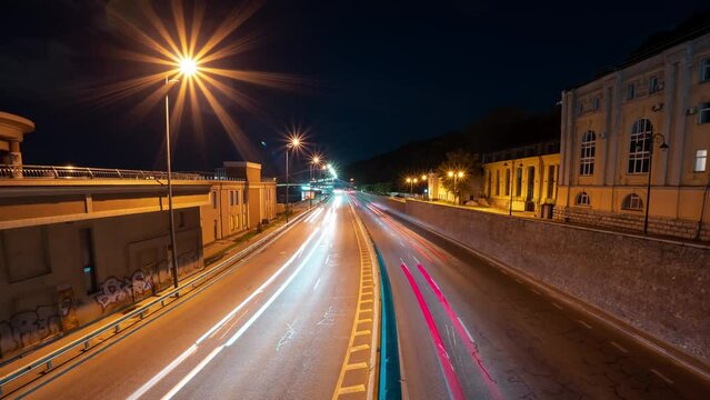A vivid time-lapse of a fast night drive through a big city at night.