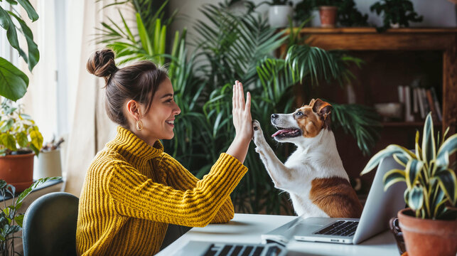 Joyful Indoor High-Five: Woman and Dog Celebrating Together at Home Office