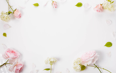 Fototapeta na wymiar Festive flower composition on white background. Overhead view, flat lay, frame
