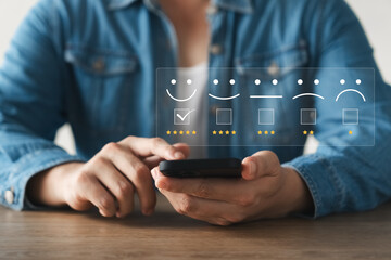 customer satisfaction survey concept business people use smartphone Touch the happy smiley icon....