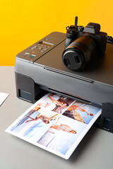 Printer and photo camera on table. Printing photos concept