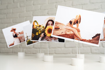 Printed colorful photos of women portraits. Printing photos concept - obrazy, fototapety, plakaty