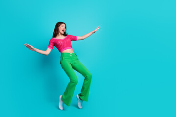 Fototapeta na wymiar Full size photo of astonished girl wear pink top green trousers staring at impressive sale empty space isolated on blue color background