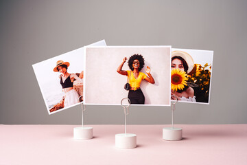 Printed colorful photos of women portraits against gray background