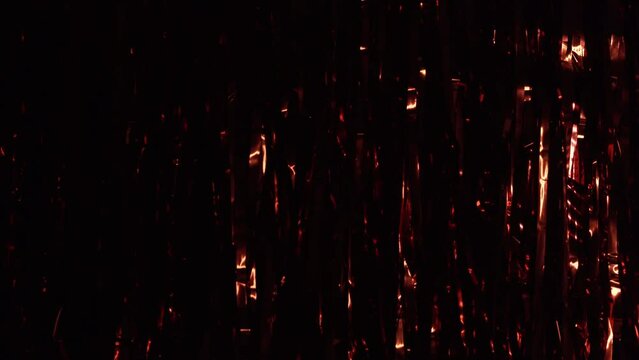 Festive red tinsel. Red shower as background and texture. Party Background. Decor foil and tinsel. Festive