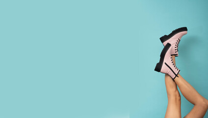 Women's legs raised in shoes.