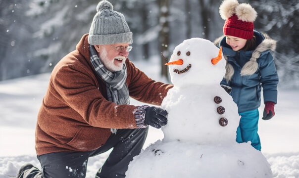 Grandparent and child playing in the snow building a snowman. Holiday season activity 