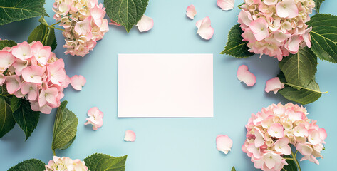 Invitation card mockup with empty paper blank, flowers frame