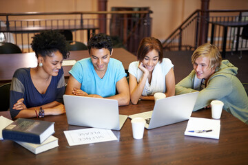Teamwork, laptop or students studying together in school, university library or college for...
