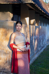 Young beautiful Asian woman wearing thai traditional dress posting at ancient temple with old pagoda in Chiang Mai, Thailand. Asia woman wearing traditional.Young Thai woman wears Thai dress worship