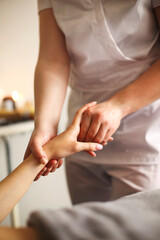 Woman masseur giving massage to client