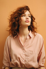 Portrait of beautiful young woman with curly hair on beige background