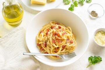 Italian pasta dish with crisp pancetta bacon, parmesan cheese and black pepper.
