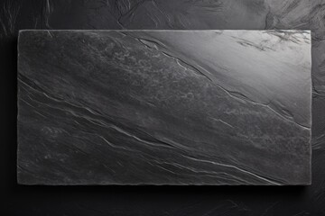 Empty black granite board on textured cement background, top view with copy space. - obrazy, fototapety, plakaty