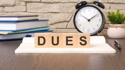 cubes form the word dues. dues word concept - finance, market and investment