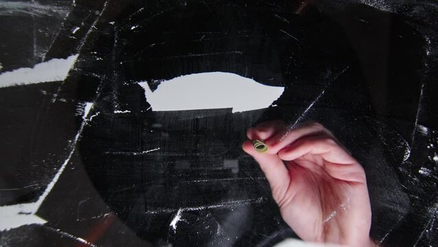 Сoncept of drug addiction and social degradation with cocaine or heroin addict sniffing a row of cocaine crushed pills with a twisted dollar bill, closeup