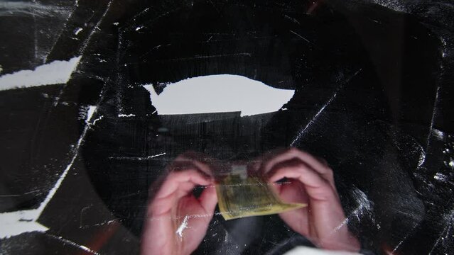 Hand rolls 100 dollars with cocaine snorted on a black glass, drug addiction