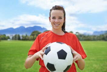 Woman, soccer player and portrait with ball, confident and football field for match, competition or game. Fitness, practice and ready for training, outdoor and exercise for athlete, strong or sport