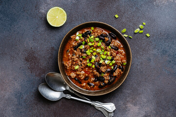 Beef chili con carne with green onions directly above