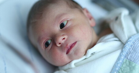 Baby newborn infant inside hospital crib after birth