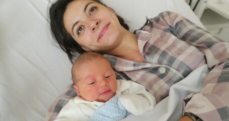 Fototapeta na wymiar Baby newborn with mom layed in hospital bed