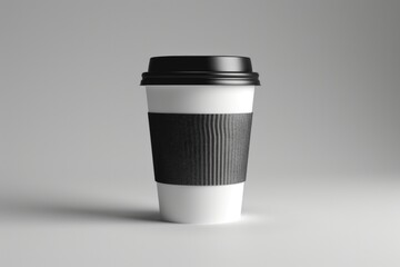 A black and white coffee cup placed on a table. Suitable for various uses