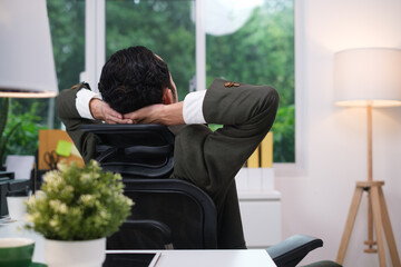 Employee is doing a relaxing posture after a hard work, Happy businessman resting at work after work is finished, success, Relax, Attractive, Stretch oneself, Stretch oneself out the arms.