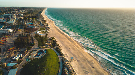 aerial View of a skate bowl in the white sand beach of Scarborough in Perth during a golden sunset...