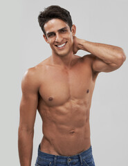 Man, portrait and happy or shirtless bodybuilder in studio, smile and fitness by gray background. Male person, abs and strong core or muscular abdomen, confident and results or progress from exercise