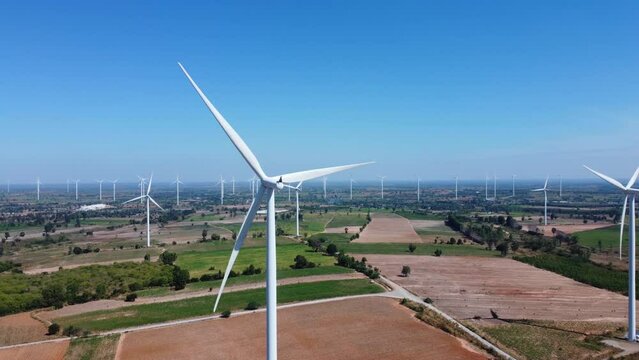 An aerial picture of a contemporary wind farm in motion that produces electricity. It is an example of environmental conservation and innovation in the electric business, and it is clean and renewable