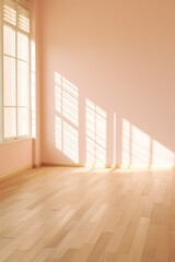 Fototapeta na wymiar Light peach wall and wooden parquet floor, sunrays and shadows from window 