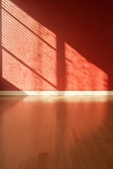 Light red wall and wooden parquet floor, sunrays and shadows from window 