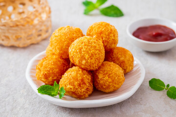 Deep fried cheese balls on plate and ketchup