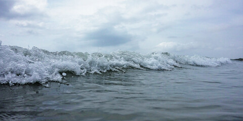 clouds over the sea, close up of the wave