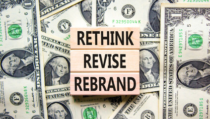 Rethink revise rebrand symbol. Concept word Rethink Revise Rebrand on block. Dollar bills....