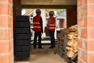 Building inspector and foreman conducting inspection of construction object