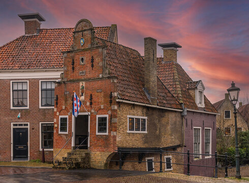A historical house from 1634 known as Korendragershuisje with the flag of Province Friesland located in the city of Franeker, The Netherlands