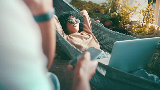 Woman, laptop and relaxing in outdoors on vacation, internet connection and resting on getaway. Black female person, sunglasses and lying on hammock, streaming movie and tech for series on holiday
