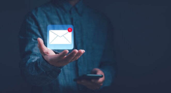 concept of email notification ,Business email communication, Internet technology ,online marketing . man shows envelope icon on hand. Show electronic message inbox notifications