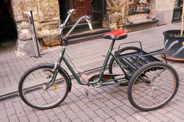 Fototapeta na wymiar Vintage adult tricycle bike: A classic three-wheeled bicycle with timeless charm, evoking nostalgia and showcasing the enduring elegance of a bygone era.