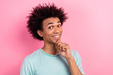 Photo of smart clever man dressed blue t-shirt arm chin smiling empty space isolated pink color background