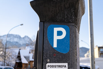 Parking meter, Parkometr or Parkomat in paid parking zone of Zakopane city, Poland. Town car park pay and display ticket machine. Tatra Mountains Giewont in background. Podstrefa means subzone. - obrazy, fototapety, plakaty