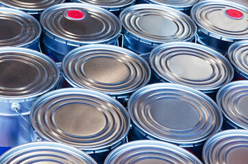 New sealed paint buckets stacked next to each other.